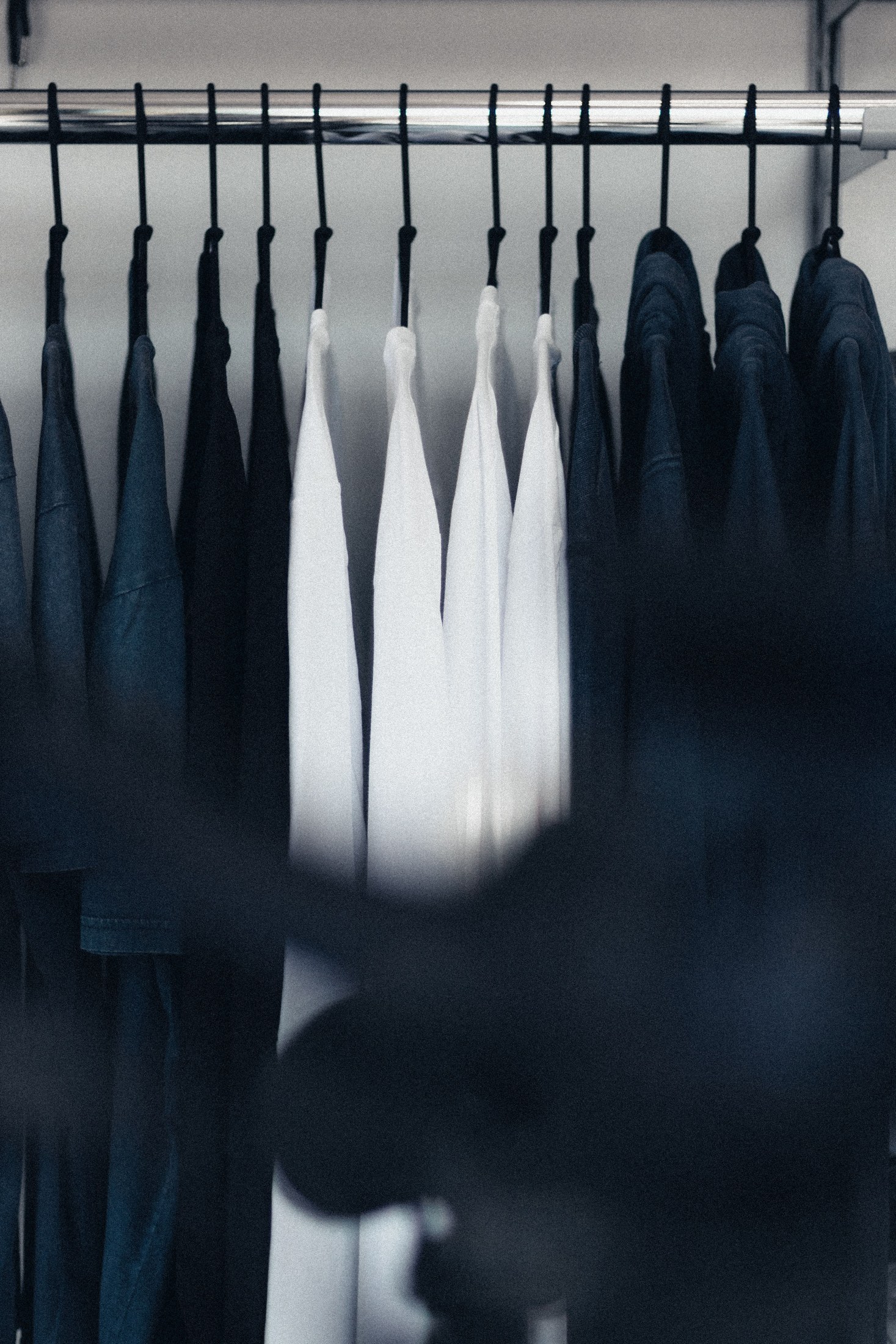 A restrained black-and-white wardrobe on a rail