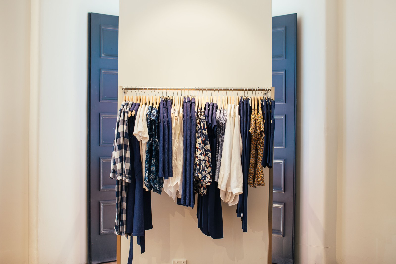 A wardrobe rail with hanging clothes and room to inspect them