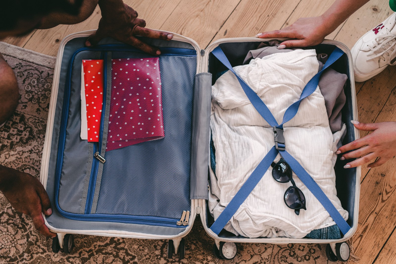 An open packed suitcase with clothing and travel essentials