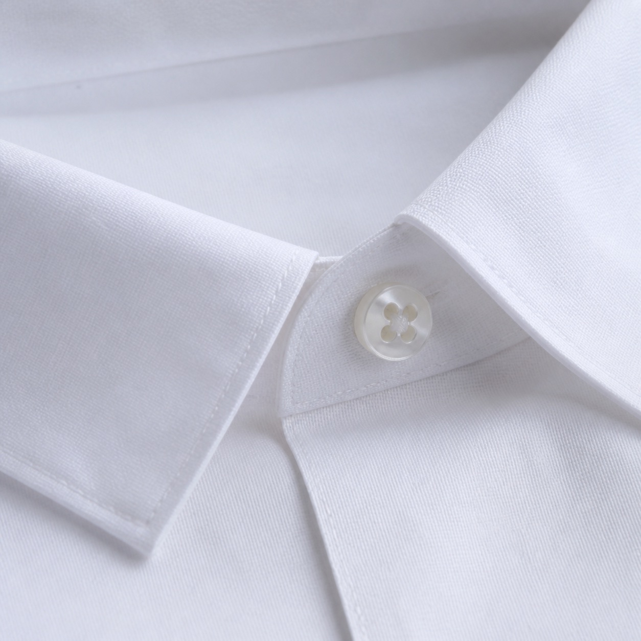 Detail of a crisp white shirt collar and cotton fabric